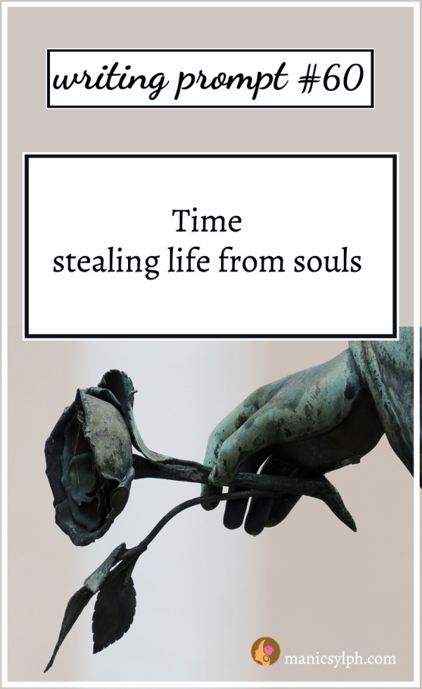 A stone hand holding a rose and writing prompt 60 written on it