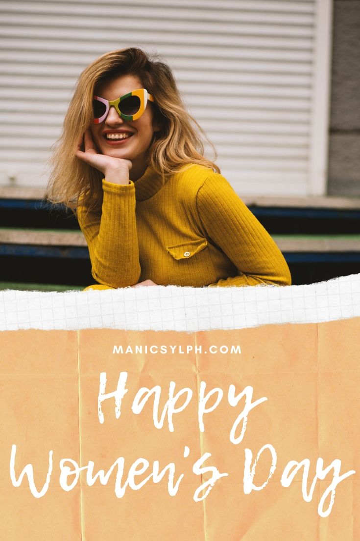 A smiling woman wearing a yellow sweater, with Happy Women's Day written on the picture