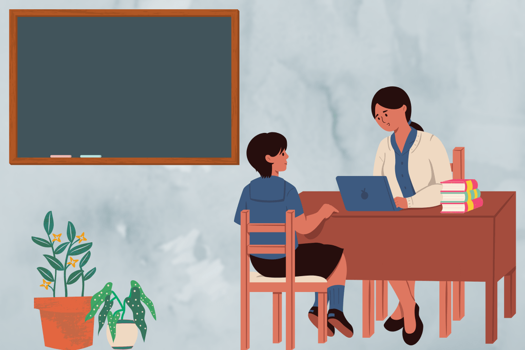 A teacher sitting at her computer with a student