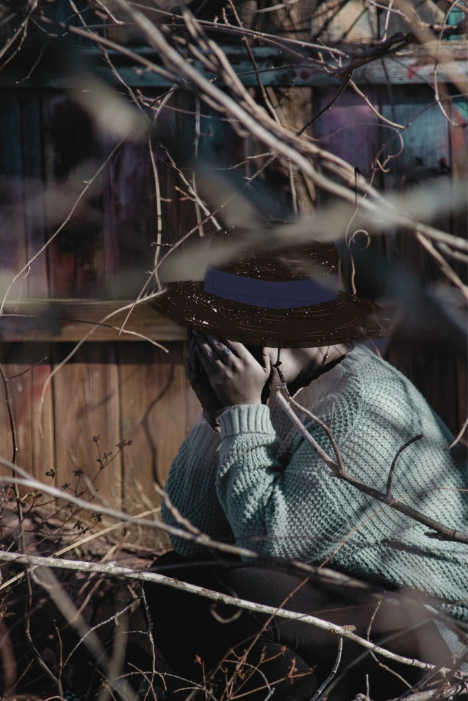 A woman in a hat sitting on a fallen tree and crying (story illustration by Glen Giles)