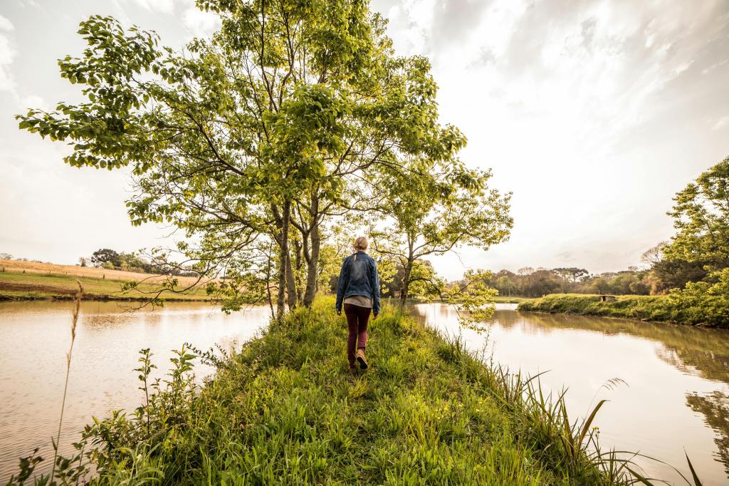 Woman walking along a stream