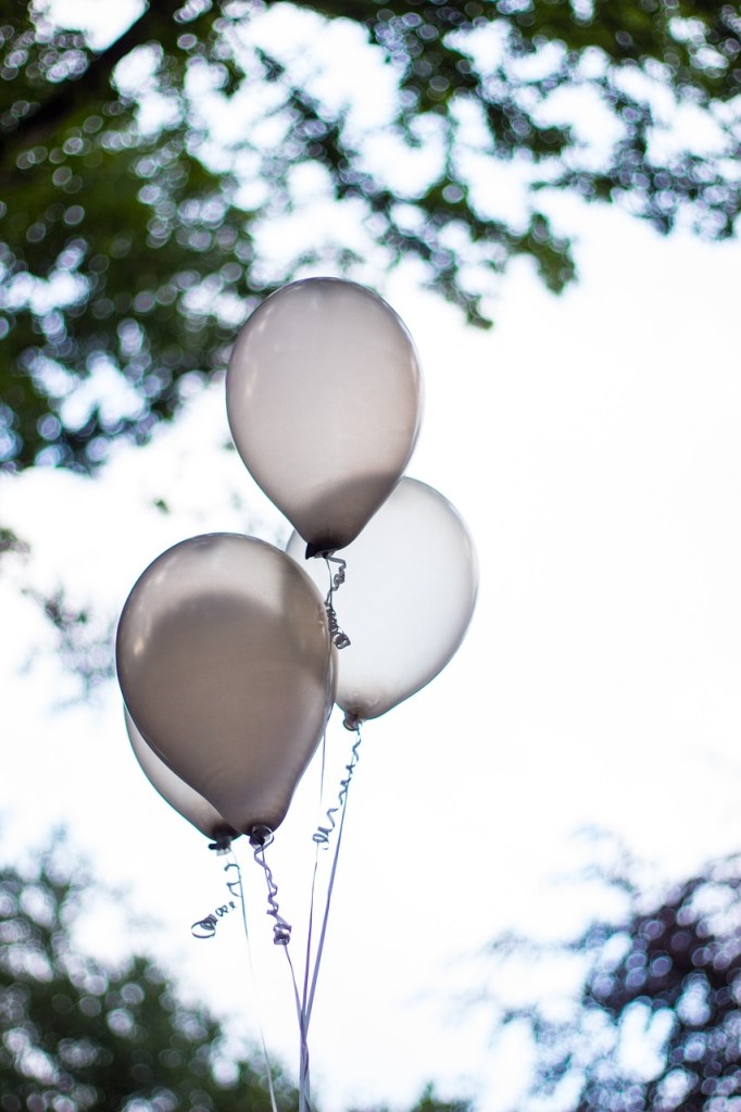 faded party balloons hovering in the air