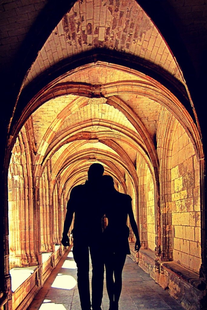 Couple walking together in the orange golden light of the sunset